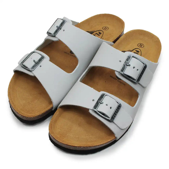 Pale grey sandals with brown soles on a white background