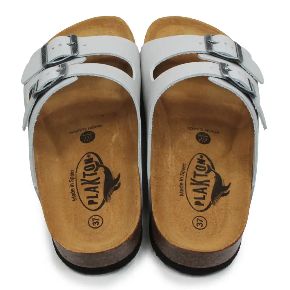 Pale grey sandals with brown soles on a white background