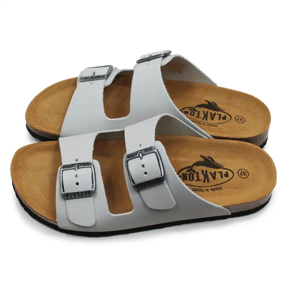 Pale grey sandals with brown soles on a white background