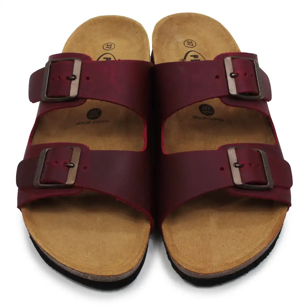 Pair of maroon sandals with brown soles on a white background
