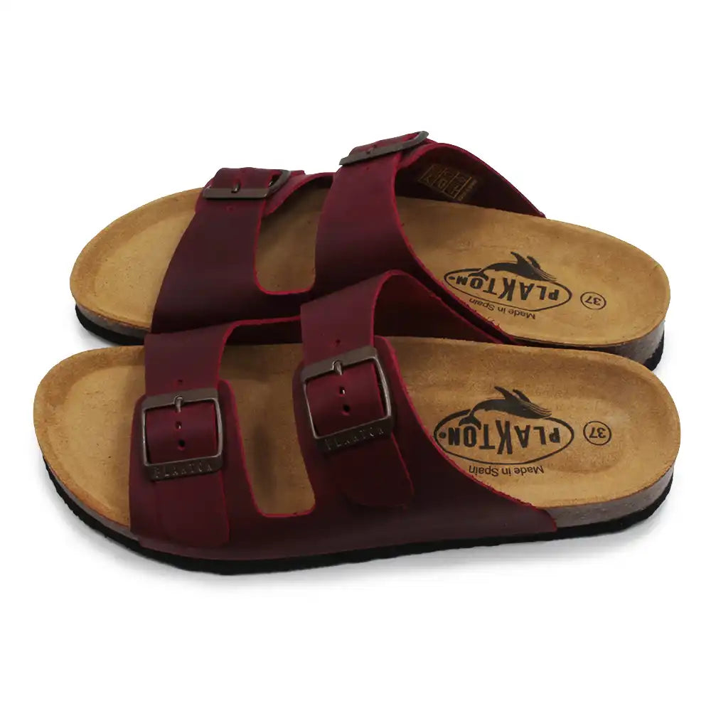 Pair of maroon sandals with wooden soles on a white background
