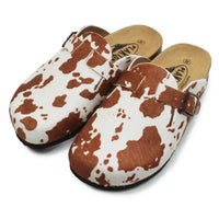 Pair of cow print clogs with a strap on a white background