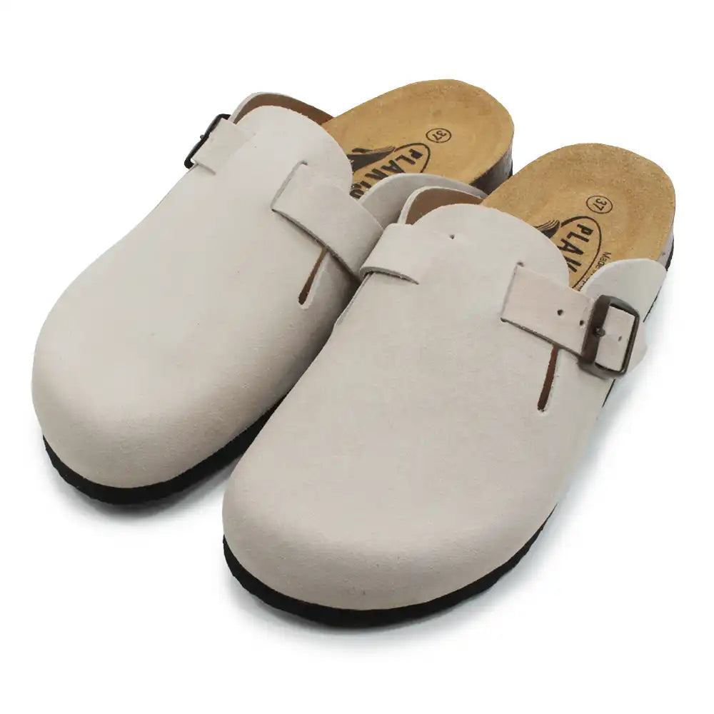 Beige open backed clogs on white background.