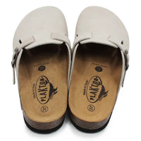 Beige open backed clogs on white background.