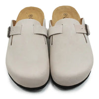 Beige open backed clogs on white background.