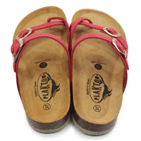 Pair of sandals with pink straps and cork soles on a white background