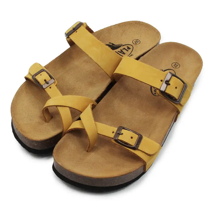 Mustard double buckled strappy sandals on a white background.