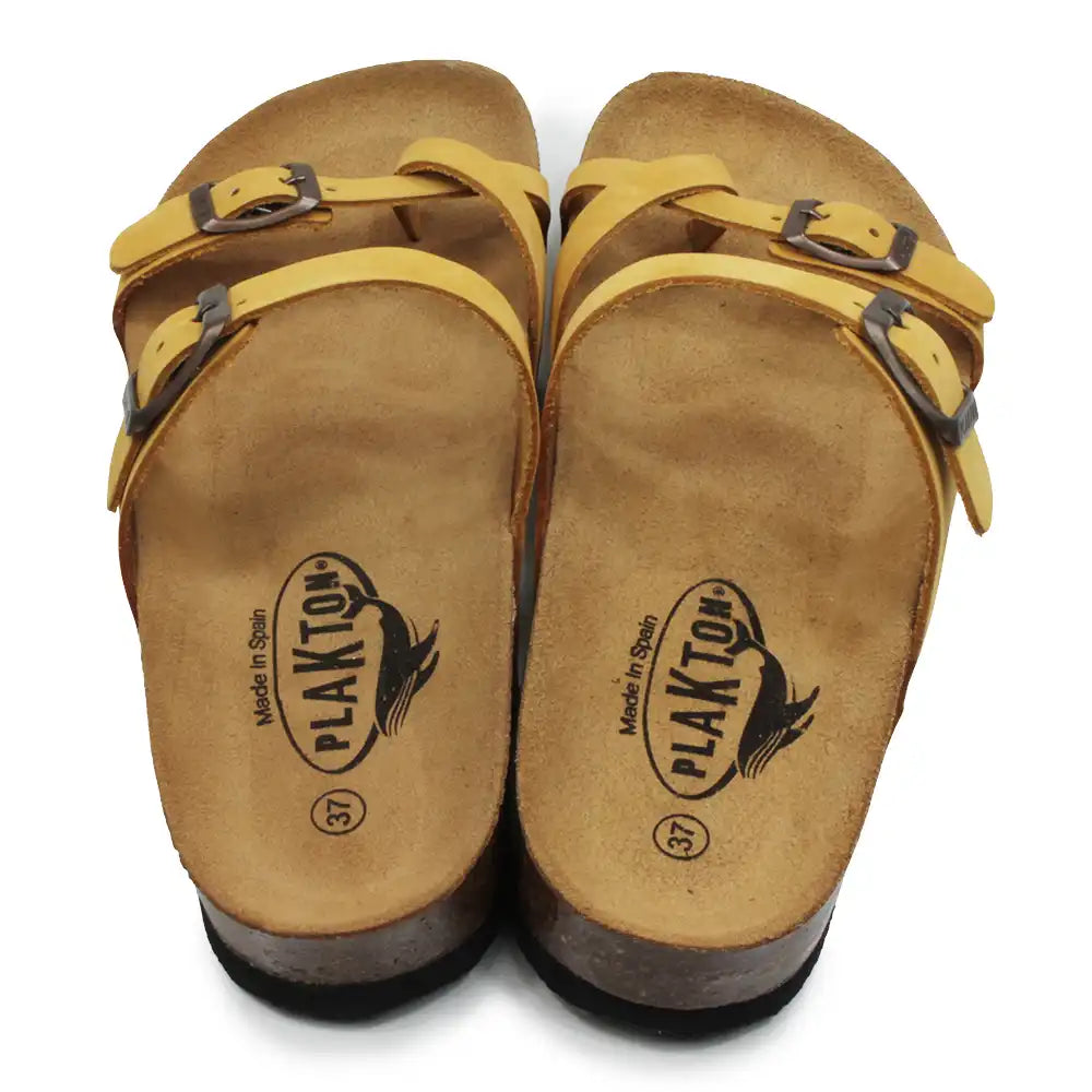 Mustard double buckled strappy sandals on a white background.