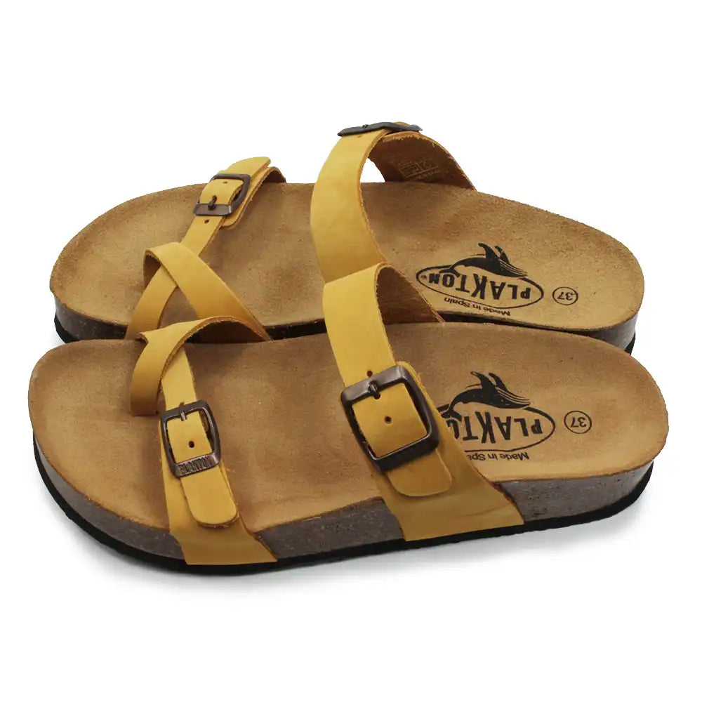 Mustard double buckled strappy sandals on a white background.