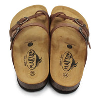 Brown buckled strappy sandals on white background.