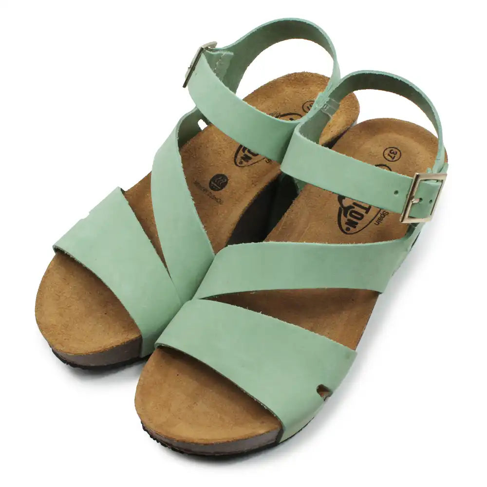 Light green strappy wedge sandals on a white background.