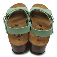 Pair of sandals with green straps on a white background