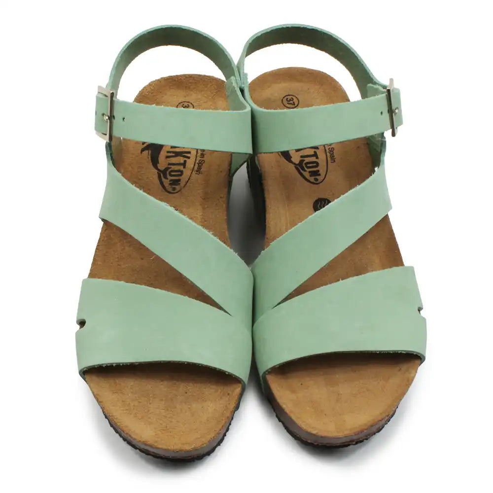 Light green strappy wedge sandals on a white background.