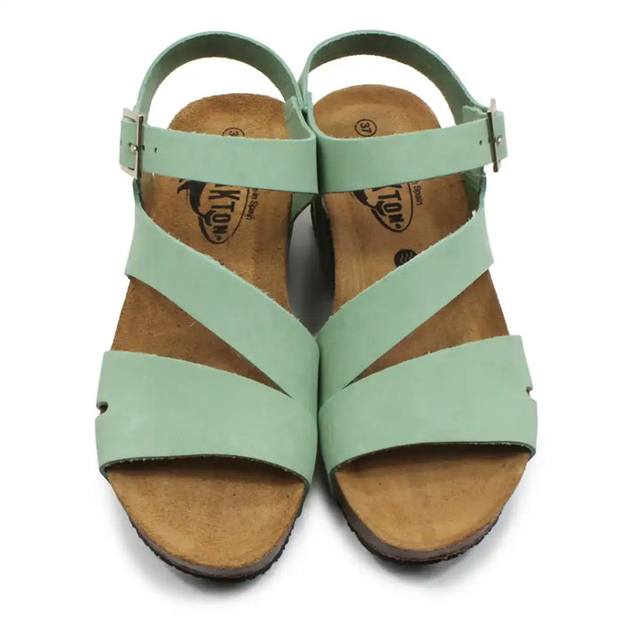 Light green strappy wedge sandals on a white background.