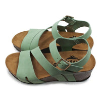Green sandals with brown soles on a white background