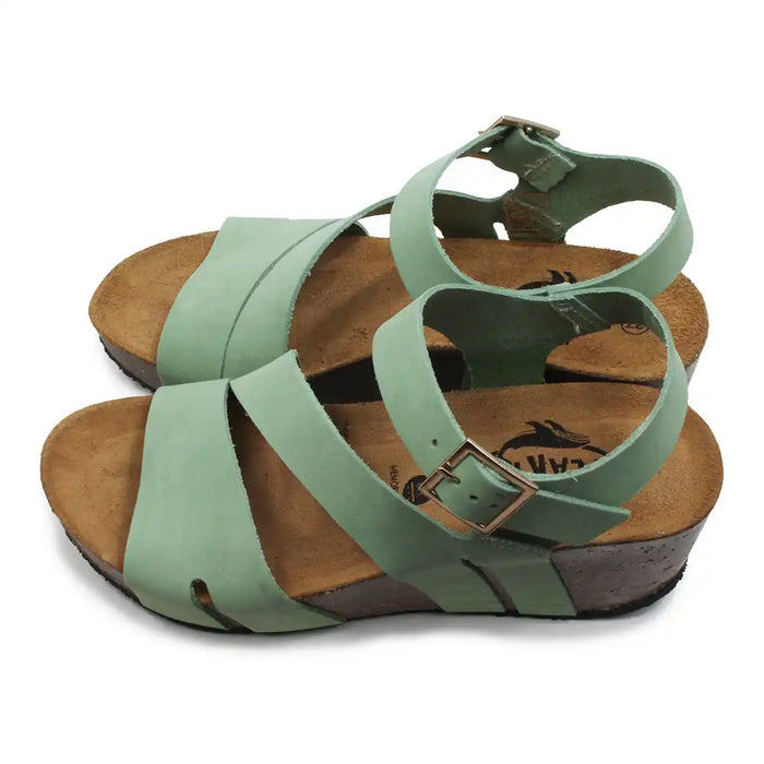 Green sandals with brown soles on a white background