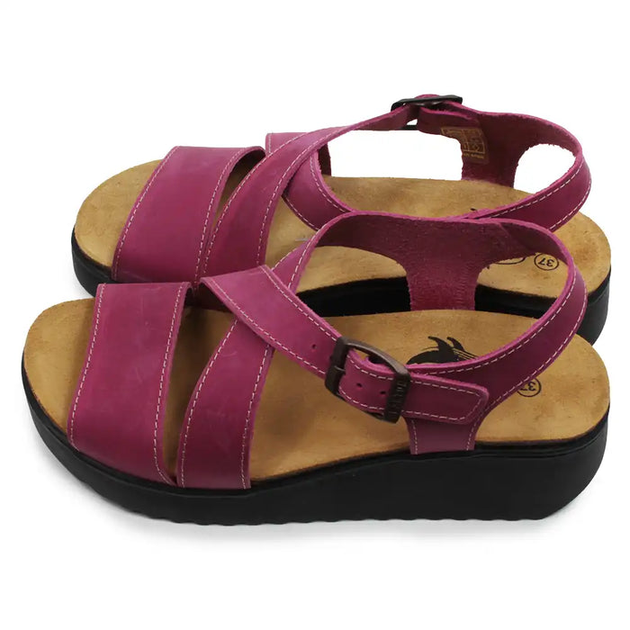 Pair of fuchsia sandals with brown soles on a white background