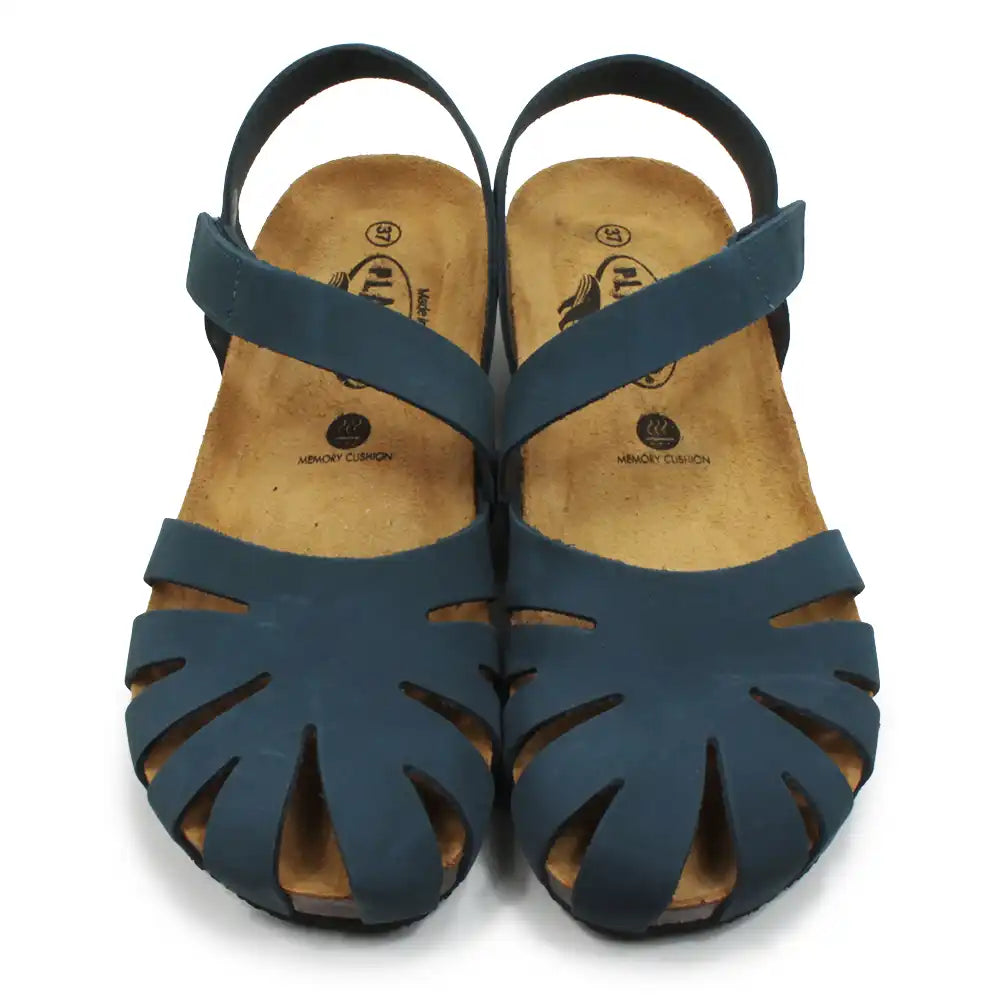 Pair of blue sandals with cut-out design on a white background
