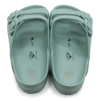 Green teal EVA waterproof double bucked sandals against a white background.