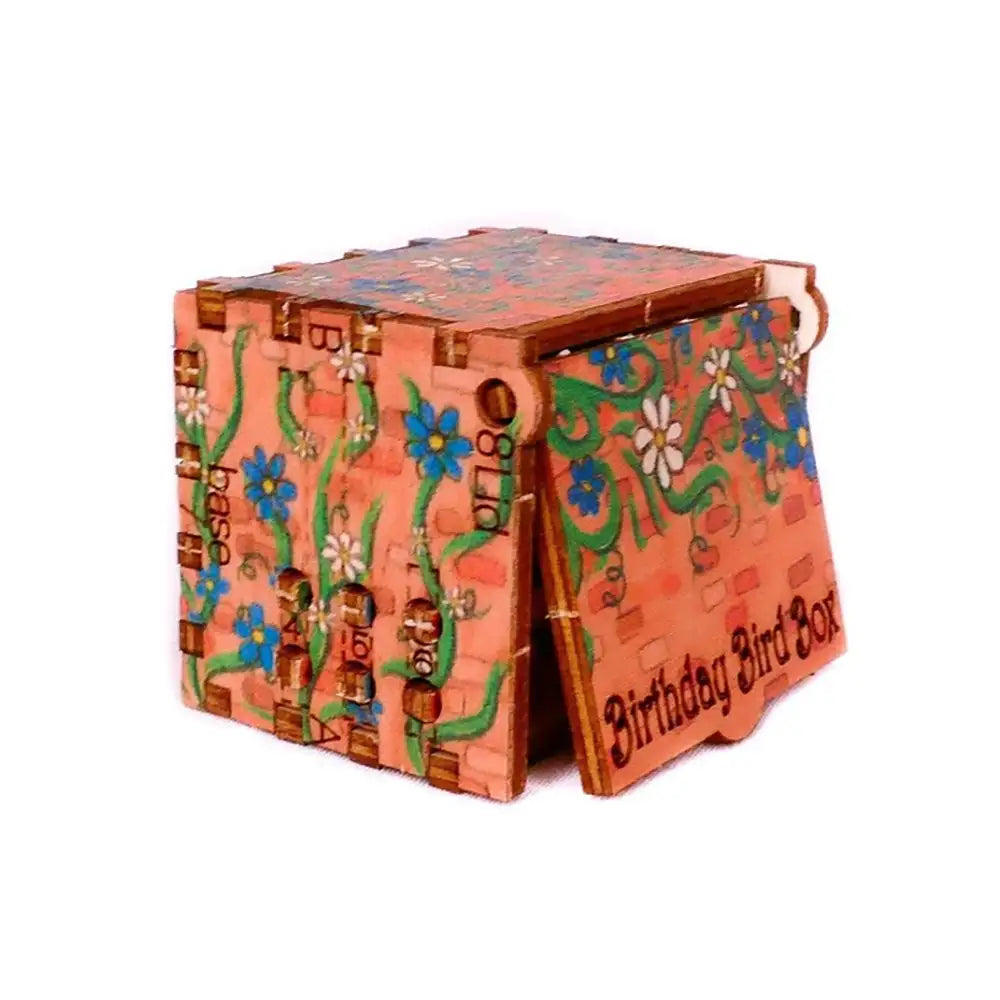 Decorative birthday bird box with floral patterns on a white background