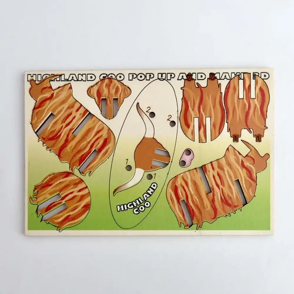 A wooden pop-up and match puzzle for children featuring cartoon illustrations of a Highland cow in orange-brown striped patterns on a light green background.