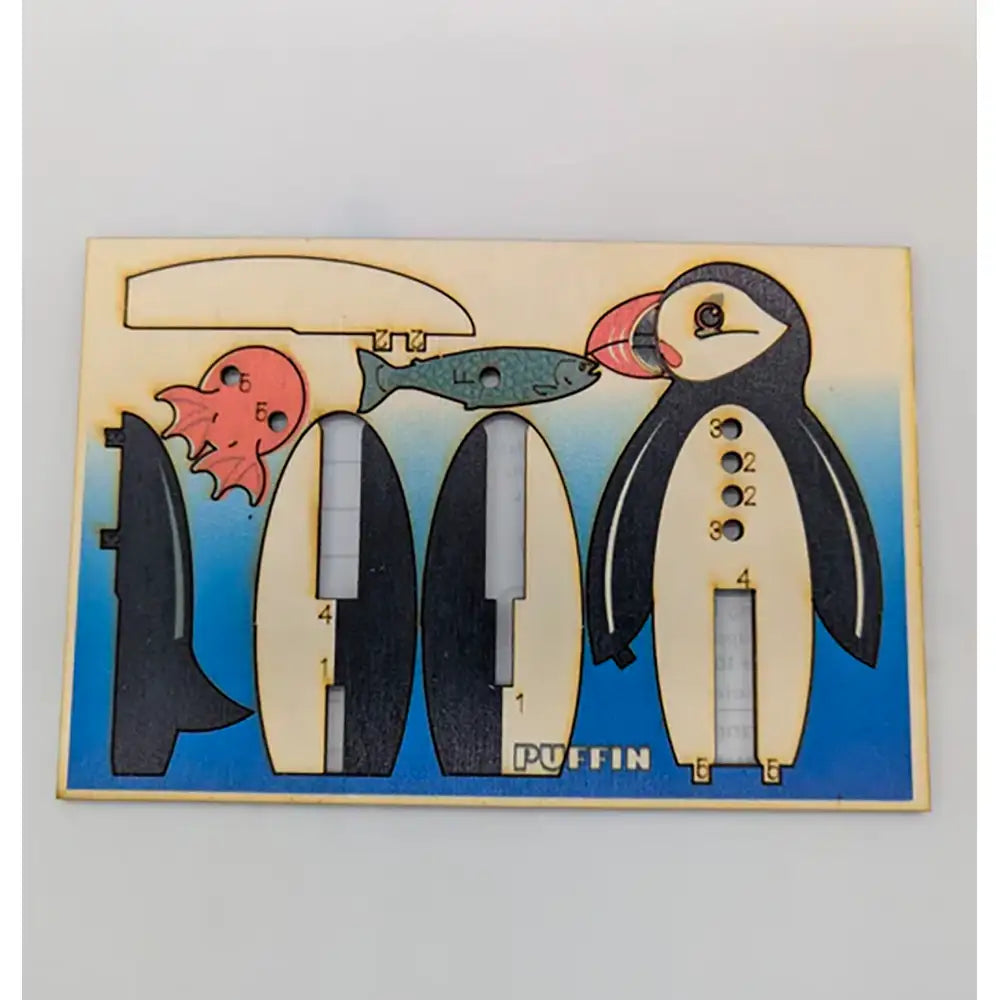 Wooden puzzle with penguin design on a light gray background