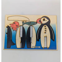 Wooden puzzle with penguin design on a light gray background