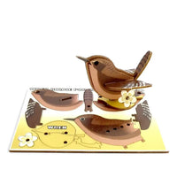 Cardboard model of a wren bird with a yellow background