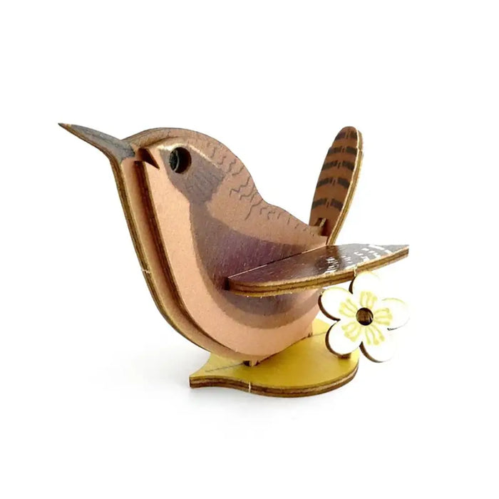 Wooden bird figurine with a yellow flower on a white background