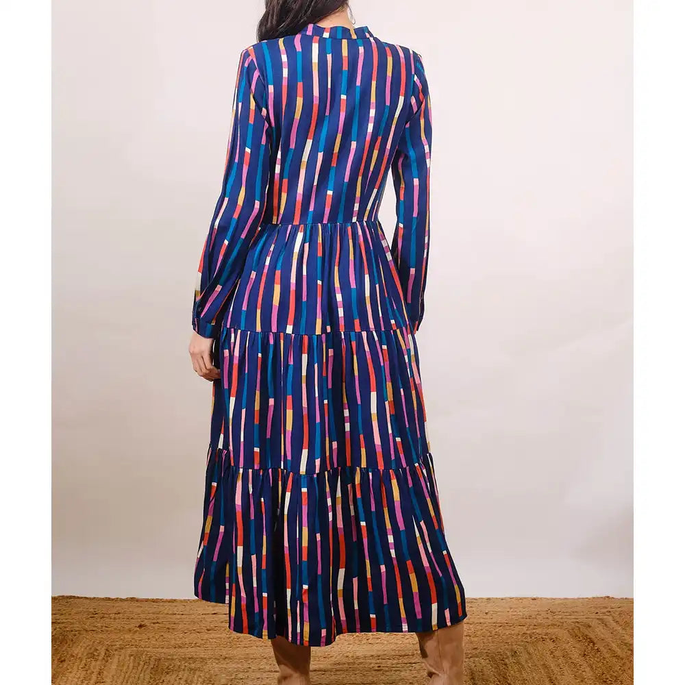 Multicolored striped dress on a plain background
