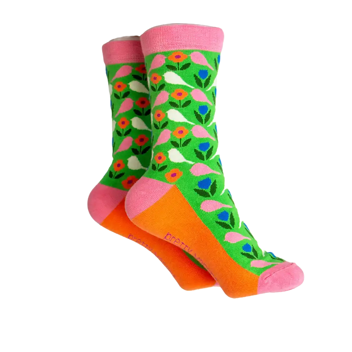 Green sock with white and pink budgies on it. Orange coloured sole with pink ankle hem, heel and toe.