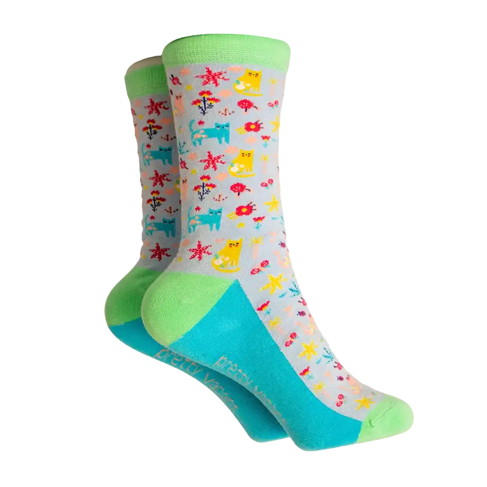 Grey based socks with a green ankle heel and toe. Bright blue sole. Covered with multi coloured cats and flowers