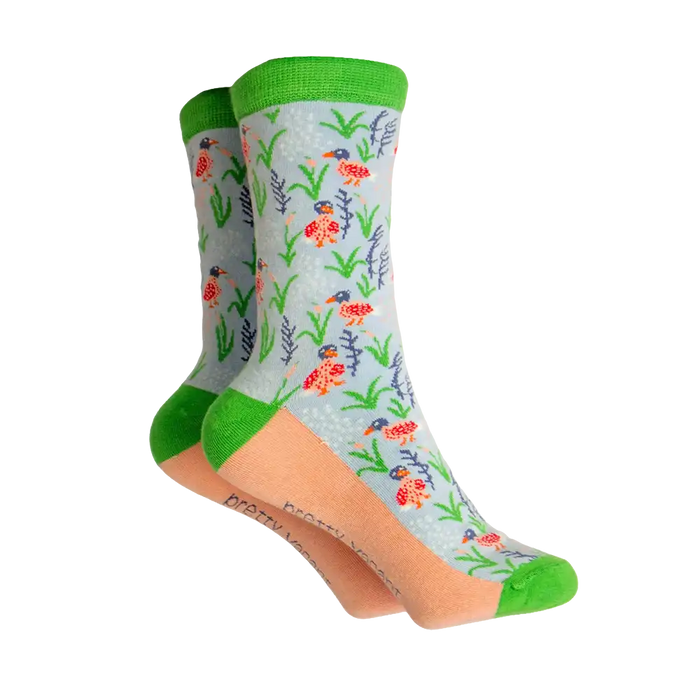Grey based socks with green ankle hem, toe and heels. Coral coloured sole with ducks and reeds on the grey. 