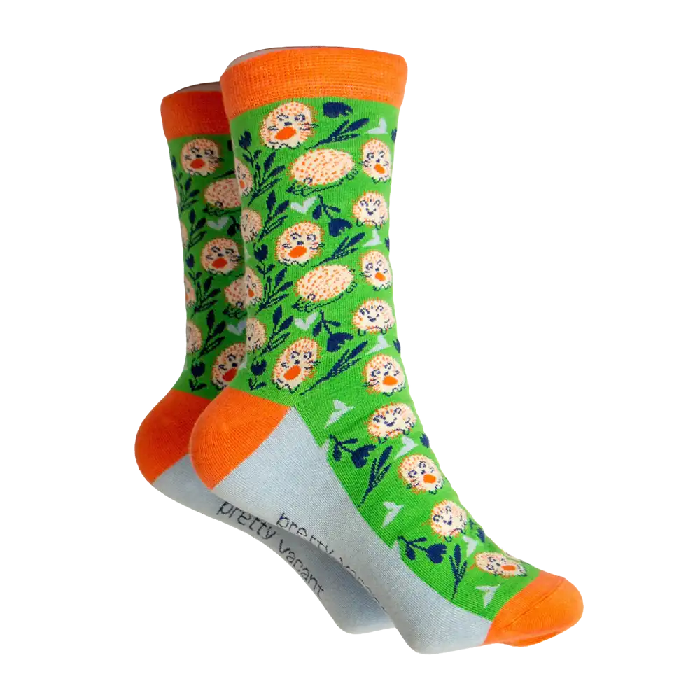 Green socks with orange and white hedge hogs on. Orange ankle, heel and toe. Grey sole.