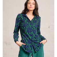 Pretty Vacant collared blouse in green with large floral pattern in dark blue. Front closer view.