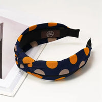 Navy based alice band with Grey and mustard spots. 