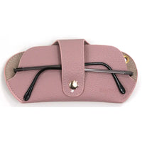 Pink glasses case with a pair of black glasses inside on a white background