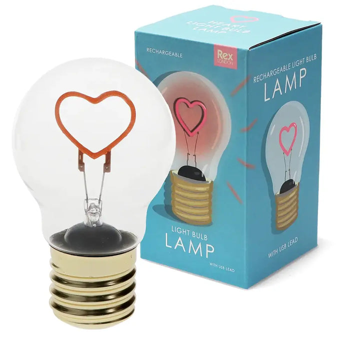 Light bulb lamp with heart-shaped filament next to its packaging