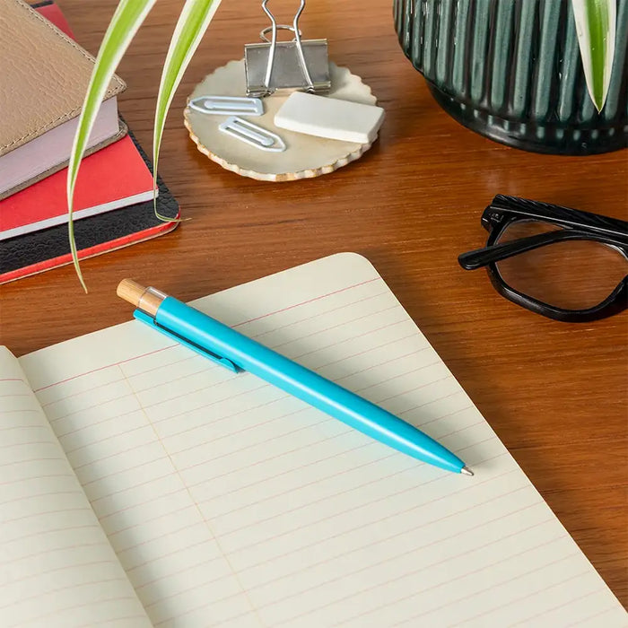 Turquoise Pen on a lined sheet of paper. 