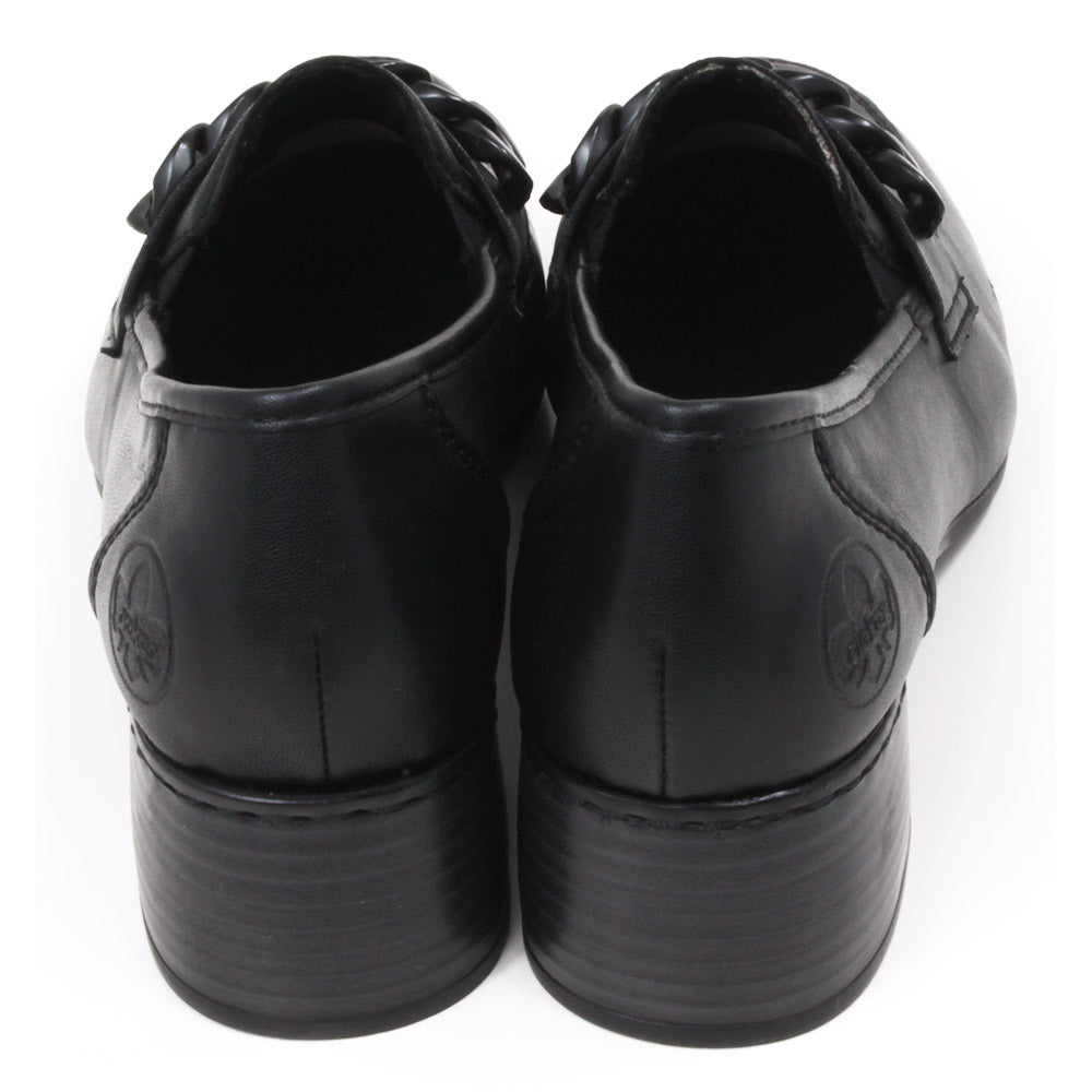 Rieker black everyday shoes with black chain foot detail and wide medium heel. Shoes shown from the back. Rieker logo pressed in to upper material at the ankle.