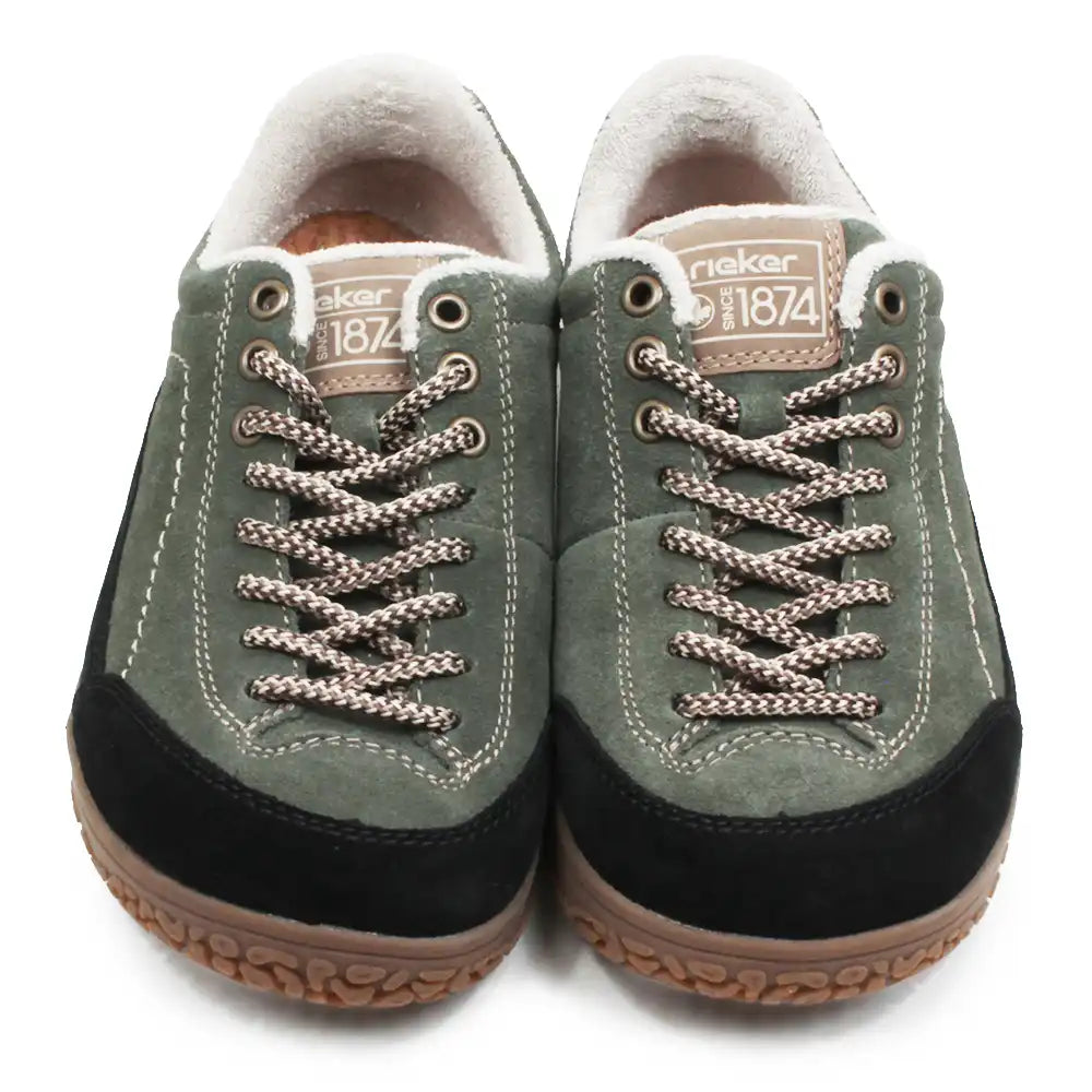 A pair of Rieker low-top sneakers in olive green suede with black suede toe caps, brown braided laces, and a white fleece lining, shown against a plain white background.