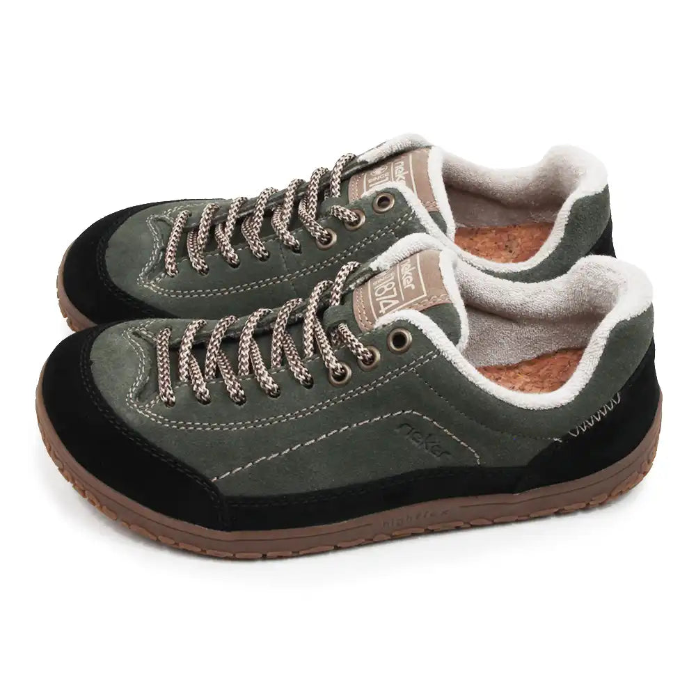 A pair of low-top casual shoes in dark olive green suede and black fabric, featuring brown braided laces, a brown outsole, and a white sherpa lining.
