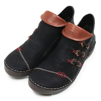 A pair of black faux leather ankle boots with brown faux leather collar trim, decorative red stitching, and brown-and-red patterned laces, shown on a white background.