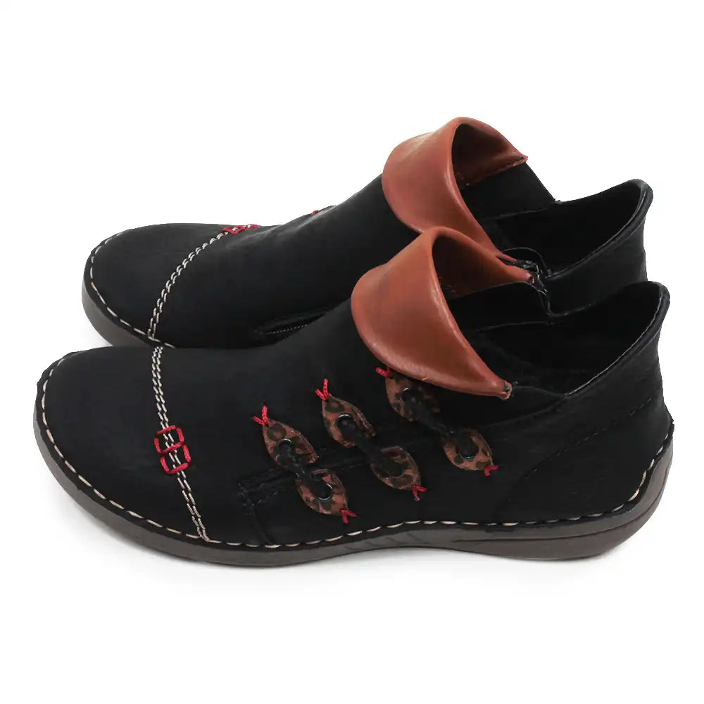 A pair of black slip-on ankle boots with brown faux leather collar accents and embroidered fish motifs on the side, shown against a plain white background.