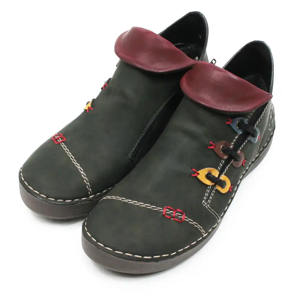 A pair of dark olive green faux leather ankle boots with burgundy faux leather collar tabs, decorative colorful chain-link details, and white contrast stitching on a white background.