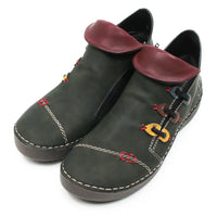 A pair of dark olive green faux leather ankle boots with burgundy faux leather collar tabs, decorative colorful chain-link details, and white contrast stitching on a white background.