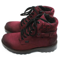 Rieker walking and activity boots in deep crimson. Black round laces in a 7 hole adjustment. Zip fastening. Wool cuffs a the ankles in a complementary mottled colour. Buckle detail at the ankle. Chunky deeply treaded soles. Side view.