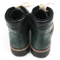 Pair of green leather boots with brown soles on a white background