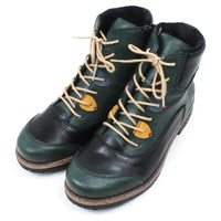 Green and black boots with beige laces on a white background