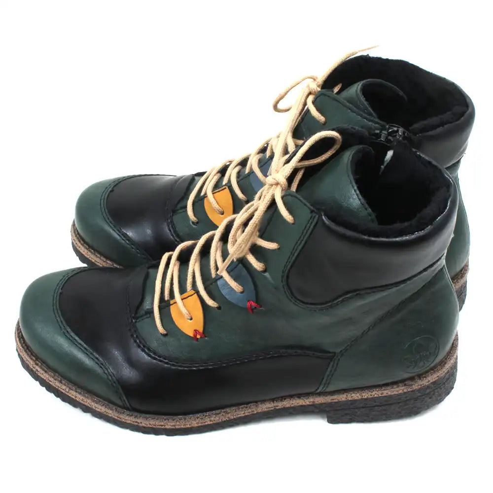 Pair of green and black boots with tan laces on a white background